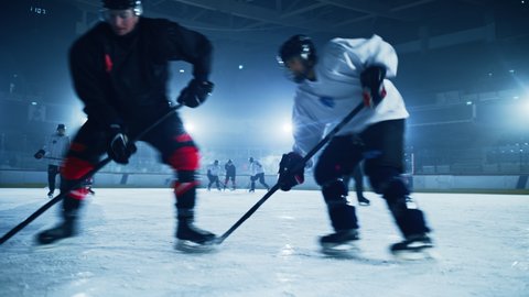 Ice Hockey Rink Arena: Professional Forward Player Attacks, Shows Expert Stickhandling, Dribbles, Handling Puck with Hockey Stick Beautifully, Defense Unable to Intercept. Tracking Wide Shot
