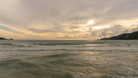 Crashing wave on sandy beach in sunset or sunrise sky over sea Time Lapse