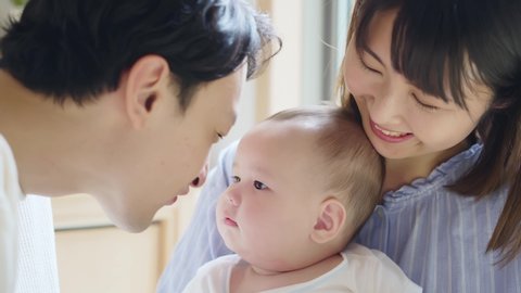 Asian parents and newborn baby. Child rearing concept.