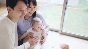 Asian parents and newborn baby. Child rearing concept.