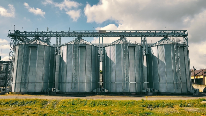Tanks for processing and storage of soybean and wheat grain. Harvesting and processing and storage elevator | Shutterstock HD Video #1075363013