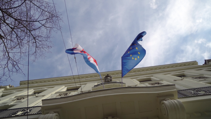 Flags of Croatia and European Union against the facade of Croatian Government building in historic Zagreb