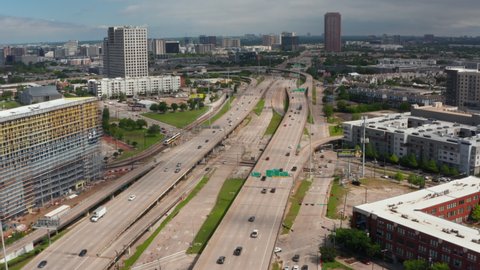 Forward flying drone over multilane highway heading to intersection. Traffic at rush hour. Aerial view of main road leading through town. Dallas, Texas, US in 2021