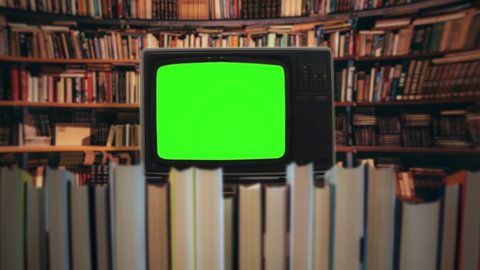 Green Screen TV Inside Library, Vintage Television Behind Books. Vintage green screen television inside a library behind books. Camera movement