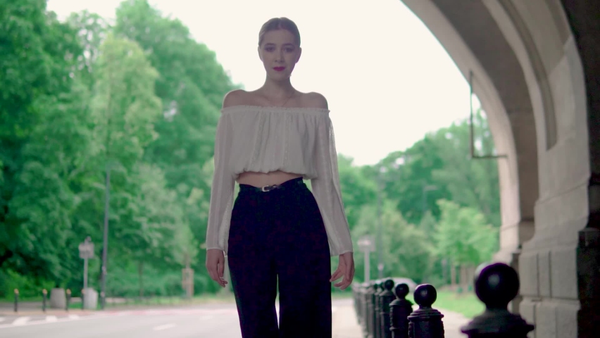 Young Girl model goes to the camera in black shoes