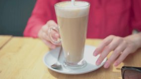Woman keeps cofee before drinking