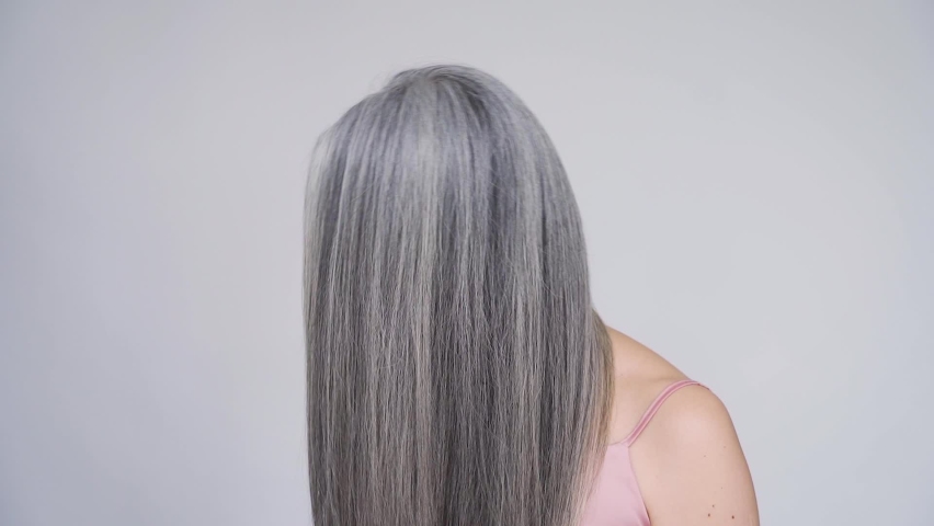 Gorgeous happy middle aged mature asian woman, senior older 50s lady smiling pampering touching hair waving grey healthy hair looking at camera. Ads of hair care, senior haircare advertising. | Shutterstock HD Video #1075376918