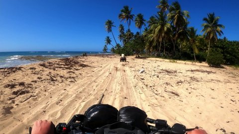 ATV rides on the beach and overtaking other bikers