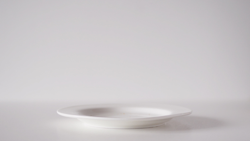 Stack of oatmeal chocolate chip cookies sprout in a plate on a white table. American cookies close up