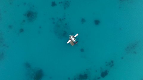 Seaplane moored in the middle of the Indian Ocean, Maldives. Seaplane transporting passengers to tropical places such as Maldivian islands, Seychelles, Australia, Bora Bora in French Polynesia