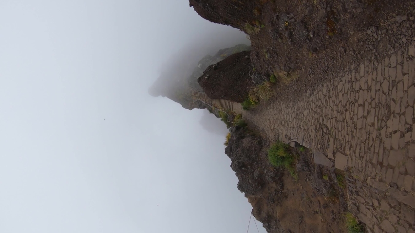 vertical video hiking path on a cloudy day with spooky fog