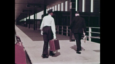 1960s: Boy holding hands with man, talking. Family walking to airport entrance. Porter helps man from car. Cars driving by airport terminal. People eating in restaurant.