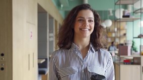 Happy latin girl student holding coffee and digital tablet walking in campus hallway greeting friends. Smiling hispanic female employee going along modern office coworking space. - Powered by Shutterstock - Get 15% off with code: PIKWIZARD15