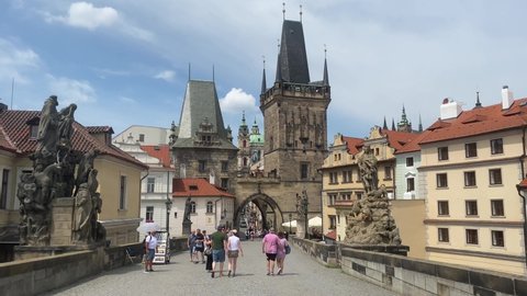 Prague, Czech Republic - June 27. 2021: Tourists are walking on Charles Bridge in Prague.