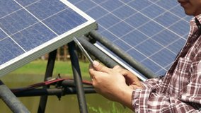 farming man holding a tablet Used to control solar panels, solar power systems. to use electricity for farming. concept of using modern farming technology - Powered by Shutterstock - Get 15% off with code: PIKWIZARD15