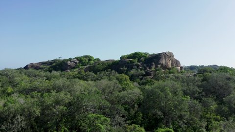 Yala National Park rocky outcrop in middle of lush jungle bright sunshine