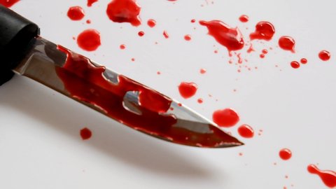 Bloody knife.Sharp knife with  blood drips on a white background with drops of blood.Crime and murder concept.