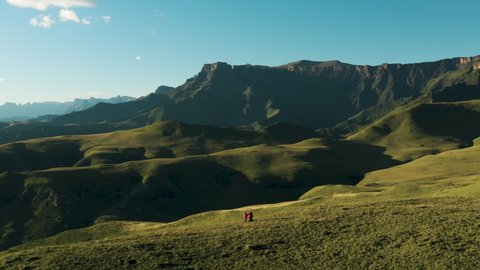 Aerial circular view of tourists standing in the Drakensberg mountains with the spectacular Amphitheatre in view, KwaZulu-Natal,South Africa