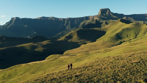Aerial view of tourists hiking in the Drakensberg mountains with the spectacular Amphitheatre in view, KwaZulu-Natal,South Africa