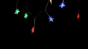A string of colorful starlike lights hanging in the dark, decorative lights - Powered by Shutterstock - Get 15% off with code: PIKWIZARD15