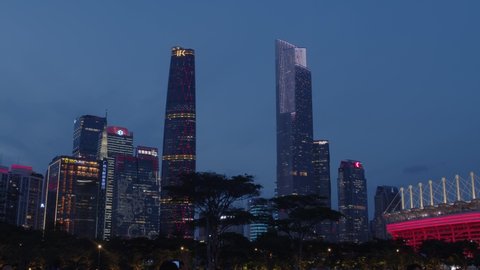 Guangzhou, Guangdong, China - July 1st 2021: View on downtown office buildings with decorative illumination during 100th anniversary of the founding of the Communist Party of China at night.