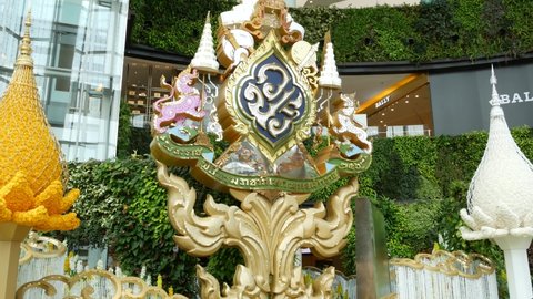 BANGKOK, THAILAND - 11 JULY, 2019: Oriental ornament placed inside mall. Royal family symbolic ornament decorating, green exterior of Siam Paragon shopping mall