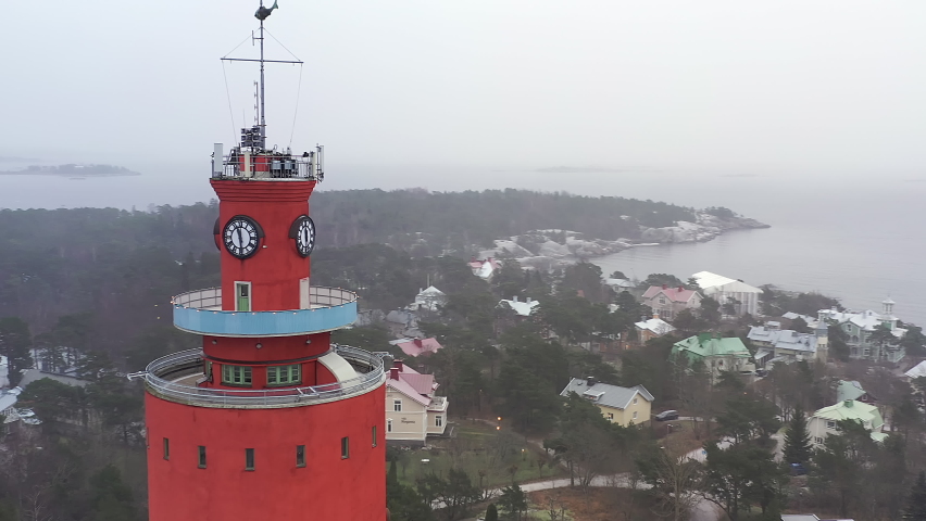 Hanko.Finland-January 3.2021: Closeup aerial shot of the water tower in Hanko Finland with the church in the background. Aerial shot with the drone moving around the water tower.