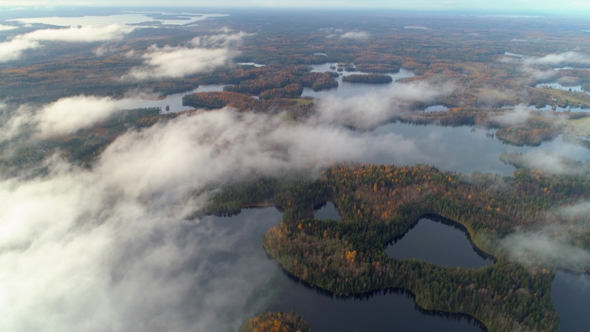 Helicoper incredible natural autumn landscape Karelia Russia swampy foggy lakes among colorful forest. Finland scenery. Mystical cinematic fog low clouds. Skerries. Ecosystem Ladoga nature park Royalty-Free Stock Footage #1075426763