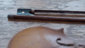 Antique retro classical violin, first size, on a wooden table. Close up. Musical dramatic mood.