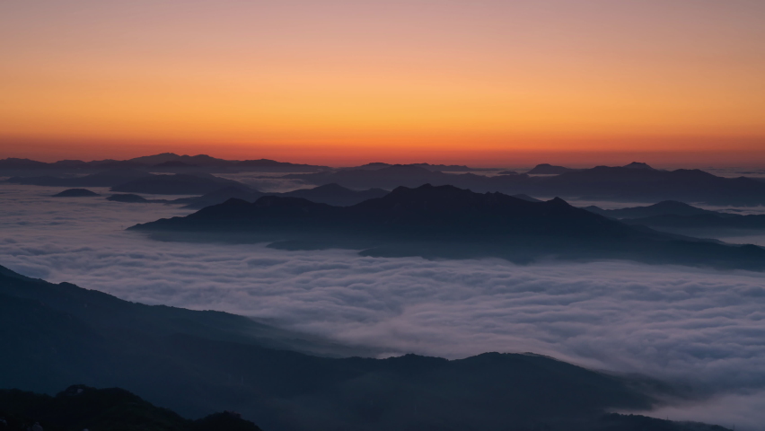 Time Lapse 4k Zoom out, morning mist cover seoul during sunrise View of the top of Bukhansan Mountain, South Korea