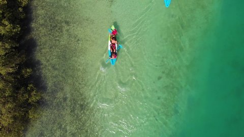 Tracking shot of people kayaking in Al Reem mangroves. Aerial, birds eye
