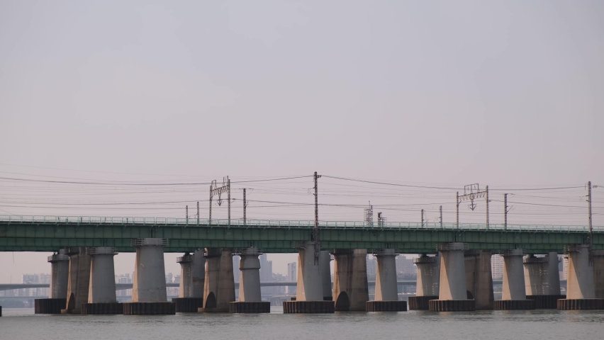 A train travels across a bridge on the Gyeongbu Expressway in Seoul, South Korea