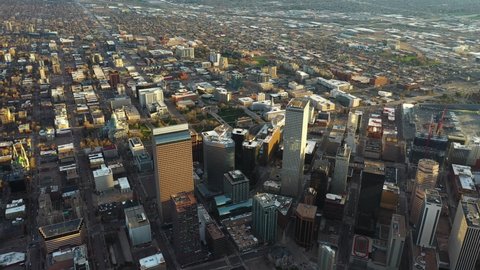 Aerial View, Downtown Denver, Colorado USA, Skyscrapers in Financial Center and Neighborhood on Golden Hour Sunset Sunlight, Drone Shot
