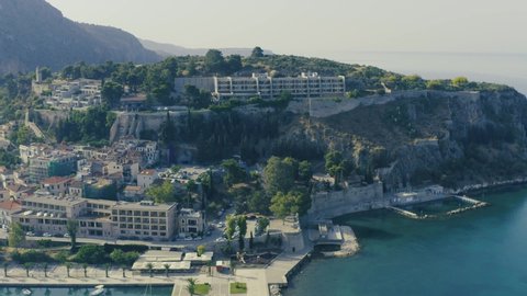 Nafplio or Nafplion city, Greece, Old town and fortress aerial drone video footage 4k.  
Peloponnese old town cityscape, Palamidi castle uphill, yachts and boats moored at the dock. 

