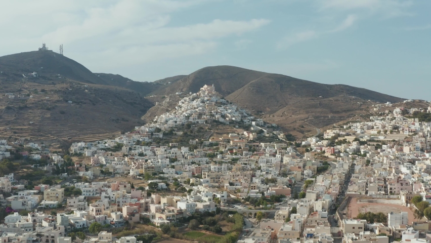 Syros island Cyclades, Greece aerial drone video footage 4k.  Chora village traditional architecture, whitewashed typical buildings on the hills, rocky landscape
