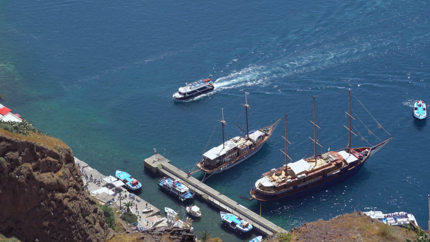 View of Aegean sea from Fira in Santorini, Greece. Harbour with boats can be seen in the deep blue