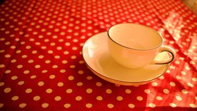 Pouring Herbal Tea To Blue Striped White Tea Cup On Matching Plate. Spotty Red Table Cloth Under Them. - Powered by Shutterstock - Get 15% off with code: PIKWIZARD15