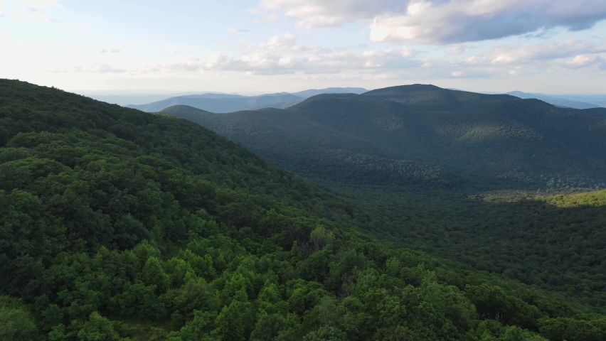 Scenic aerial overview of Shenandoah mountains and hills from above during summer sunset