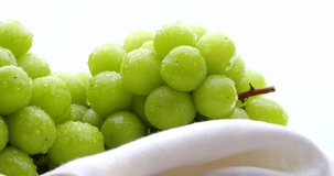 Video of two Muscat Grapes slowly rotating on a White background.