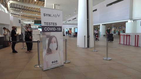 FARO, PORTUGAL – 7 JUNE 2021: Covid-19 coronavirus PRC testing sign at Faro airport in the popular Algarve region in Portugal. International tourism and travel during Summer holiday after lockdown.
