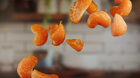 Tangerine sections in the air in slow motion