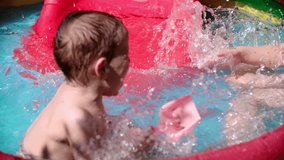 Children splashing and playing in swimming pool. Shoot on Digital Cinema Camera in slow motion-ProRes 422 codec.