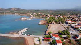4K aerial - a bird's eye view video (Ultra High Definition) of Plitra port. Sunny morning landscape of Peloponnese peninsula, Greece, Europe. Stunning summer seascape of Ionian sea.
