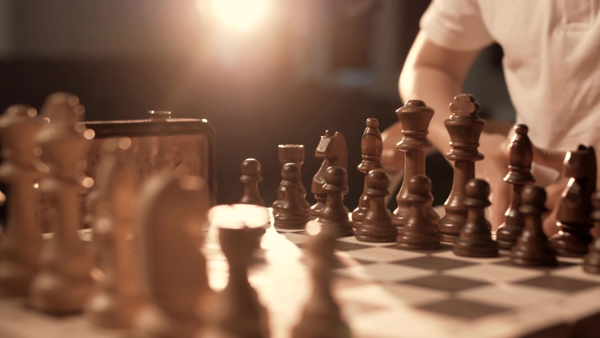 The first move of a pawn in chess. Chess board, close-up. Cinematic Royalty-Free Stock Footage #1075492373
