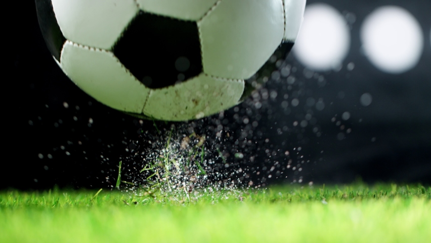 Super slow motion of falling soccer ball on lawn. Speed ramp effect. Filmed on high speed cinema camera, 1000fps. | Shutterstock HD Video #1075493486