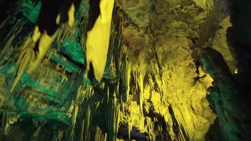 Low-angle view of stalactites and stalagmites in an underground cave Royalty-Free Stock Footage #1075498430