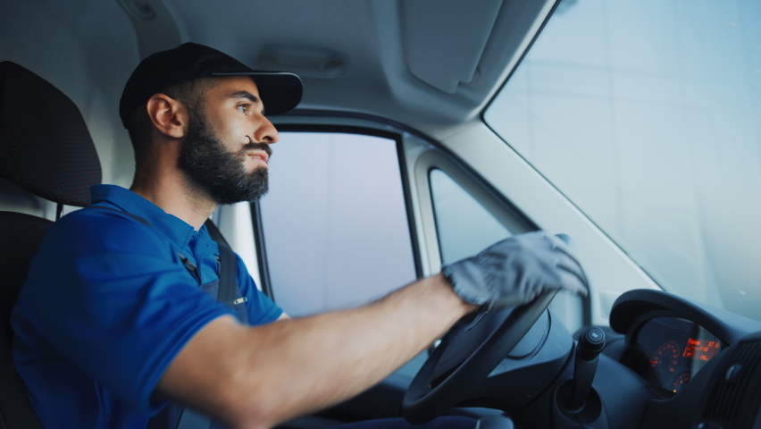 Portrait of Stylish Latin Delivery Truck Driver on the Road. Happy Professional Carefully Driving, Delivering Online Orders, E-Commerce Goods, Food, Medicine. Frontline Hero Doing Job. Inside Vehicle Royalty-Free Stock Footage #1075500908