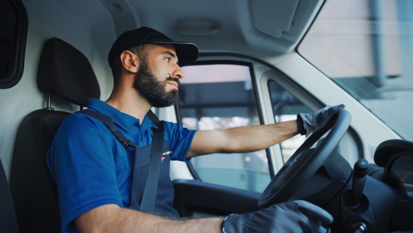 Portrait of Stylish Latin Delivery Truck Driver on the Road. Happy Professional Carefully Driving, Delivering Online Orders, E-Commerce Goods, Food, Medicine. Frontline Hero Doing Job. Inside Vehicle