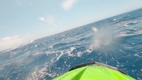 Teenager man enjoying summer in a jet ski in the middle of the sea having fun racing alone and isolated.