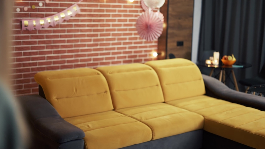 Four people in living room on sofa together having fun